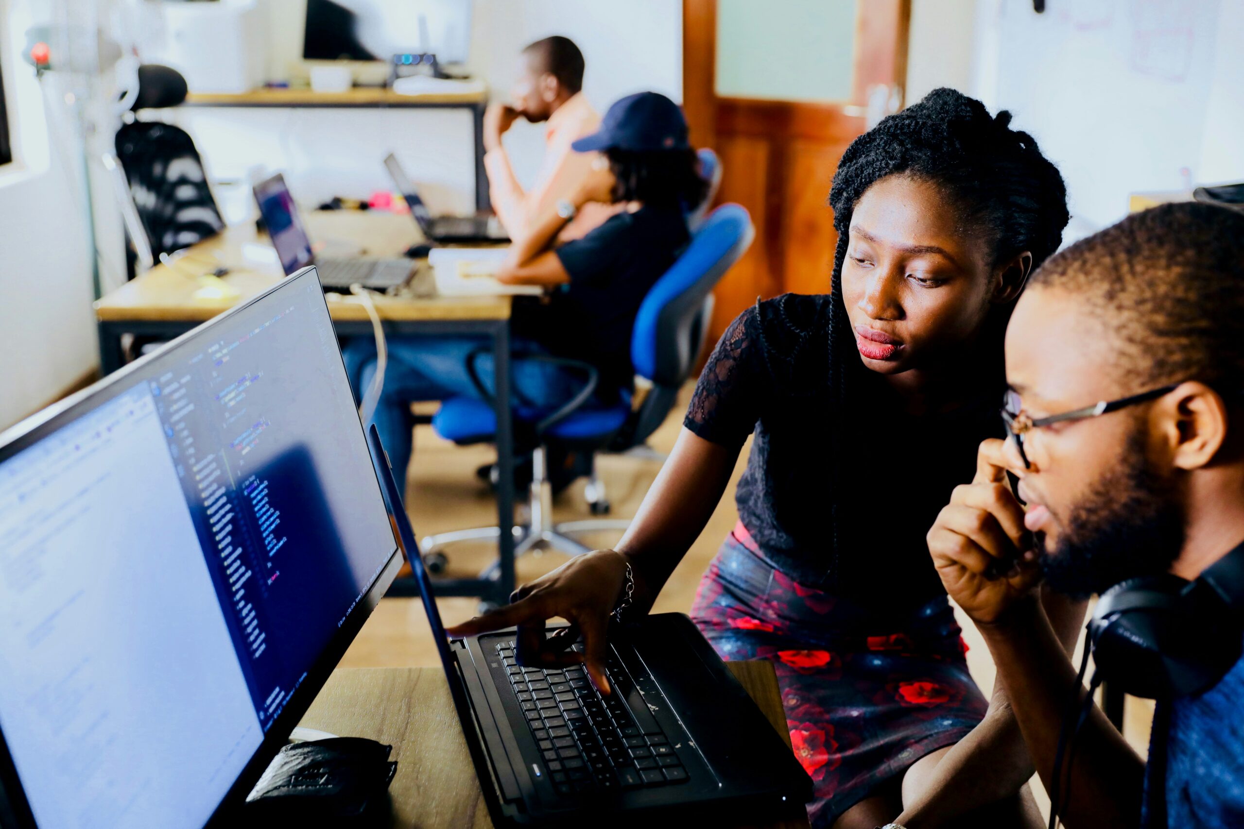 Business leader supports employee on a computer